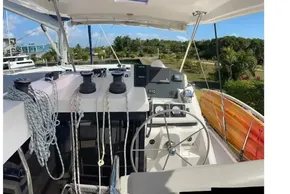 2022 Leopard 45 yacht cockpit with steering wheel, ropes, and navigation equipment.