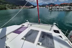 Catamaran Leopard 45, 2021 model, docked in a scenic marina with solar panels.