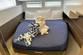 Luxurious cabin interior of 2025 Leopard 46 Powercat with elegant towel art on bed.