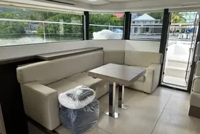 Luxurious interior of 2022 Leopard 53 Powercat yacht with modern seating and table.