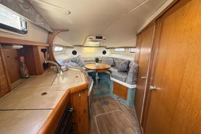 Interior of 1991 Sealine 290 Ambassador boat with cozy seating and kitchenette.