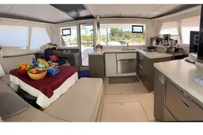 Luxurious interior of 2022 Leopard 45 yacht with modern kitchen and cozy seating area.