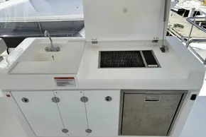 Outdoor kitchen on 2025 Robertson and Caine Leopard 46 Powercat, featuring sink and grill.