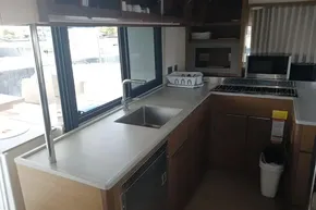 Modern kitchen interior of 2020 Lagoon 46 yacht with sink, stove, and microwave.
