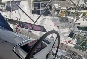 Steering wheel of a 2020 Beneteau Oceanis 46.1 yacht, docked at a marina.