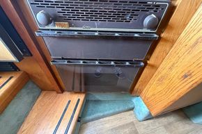 Interior view of a 1991 Sealine 290 Ambassador boat, featuring a vintage stove.