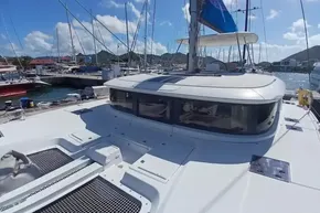 2020 Lagoon 46 catamaran docked at a marina under a clear blue sky.