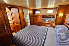 Luxurious cabin interior of 2005 Stevens 1200 Vlet yacht with wooden furnishings.