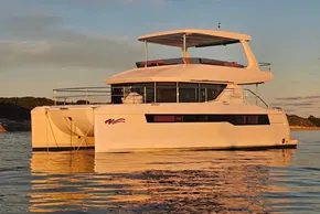 2024 Leopard 40 Powercat yacht on calm water at sunset.