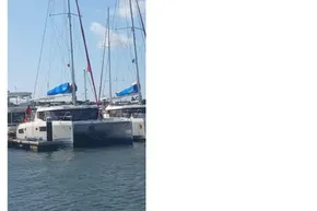2022 Leopard 45 catamaran docked at marina under clear blue sky.
