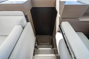 Interior stairs of 2025 Leopard 46 yacht with modern wood and fabric design.