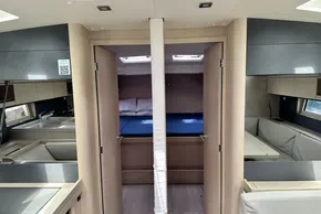Interior of 2023 Beneteau Oceanis 51.1 yacht, featuring modern kitchen and cozy cabin.