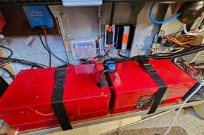 Electrical system setup in a 1921 Classic Dutch Barge, featuring red battery units.