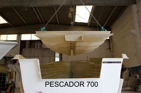 Below deck structure being lifted into place on a Pescador 700