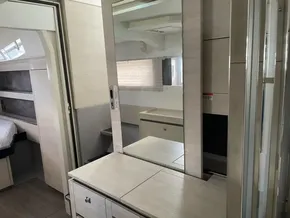 Modern interior of a 2020 Leopard 50 yacht featuring sleek cabinetry and a mirrored vanity.