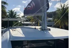 2020 Leopard 40 catamaran with sails, docked under sunny skies and palm trees.