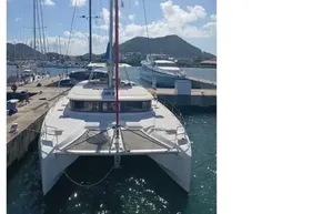 2020 Lagoon 46 catamaran docked at marina with scenic mountain backdrop.