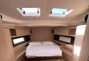 Interior of 2020 Beneteau Oceanis 46.1 yacht with cozy double bed and skylights.