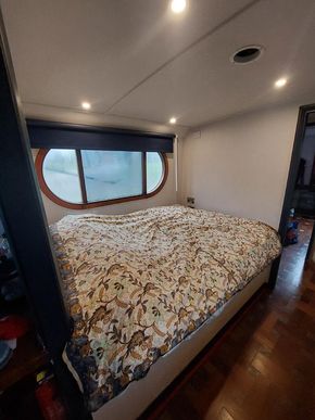 Main bedroom double bed, beneath which is lots of storage space and easy access to shower pump