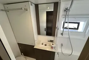 Modern bathroom in 2025 Leopard 46 Powercat by Robertson and Caine, featuring sleek fixtures and window.