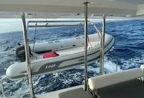 2020 Leopard 40 boat with dinghy on davits in open sea.