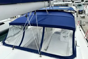 2023 Beneteau Oceanis 51.1 sailboat with blue canopy docked at marina.