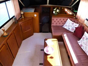 Interior of 1995 Aquafibre Bounty Boats 10/70 with cozy seating and elegant decor.