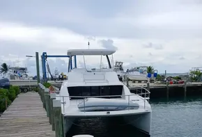 Leopard 43 Powercat 2022 docked at marina, overcast sky, wooden pier.