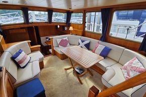 Luxurious interior of 2005 Stevens 1200 Vlet yacht with plush seating and wooden accents.