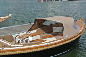 2026 Enkhuizensloep 615 boat with canopy, docked on calm water.
