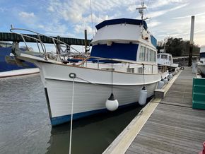 1991 Grand Banks 36 Sedan docked at marina, featuring classic design and blue accents.