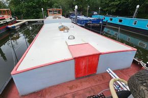 1926 Dutch Barge Luxemotor moored on a calm canal, surrounded by other boats.