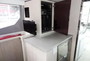 Leopard 45 yacht interior, 2017 model, featuring control panel, small TV, and storage.