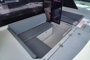 Interior seating area of a 2021 Leopard 45 catamaran, featuring gray cushions and sleek design.