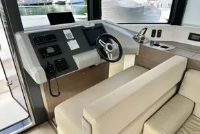 2022 Leopard 53 Powercat helm with modern controls and beige seating.