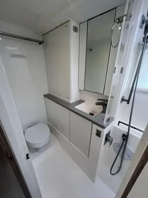 Modern bathroom in 2019 Leopard 45 yacht with shower, toilet, and mirrored cabinets.