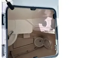 Interior view of 2022 Leopard 53 Powercat boat bathroom through open hatch.