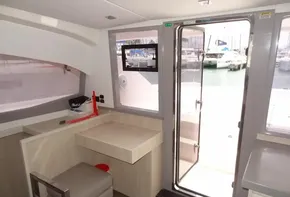 Interior of 2020 Leopard 43 Powercat yacht with desk and marina view.