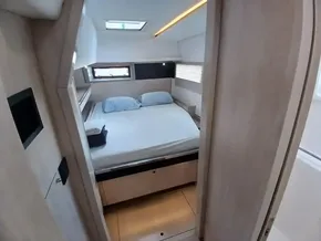 Cozy bedroom interior of 2019 Leopard 45 yacht with skylight and modern design.