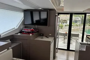 Interior of 2024 Leopard 40 Powercat with TV, modern furnishings, and sliding glass doors.