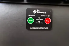Control panel of a Sea Recovery system with start and stop buttons.