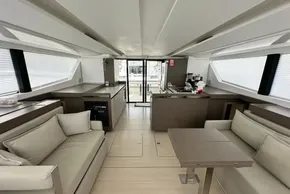 Luxurious interior of 2025 Robertson and Caine Leopard 46 Powercat, featuring modern seating and kitchen.