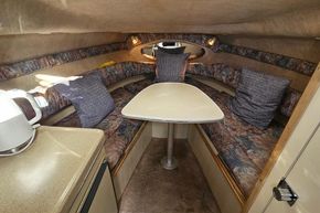 Interior of 1999 Wellcraft 2400 Martinique boat with cozy seating and table.