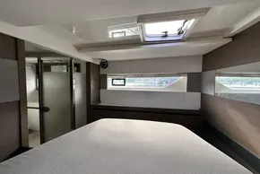 Interior of 2022 Leopard 53 Powercat yacht, featuring a modern bedroom with skylight.