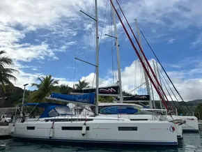 Jeanneau Sun Odyssey 440 sailboat docked, 2019 model, with clear skies and palm trees.
