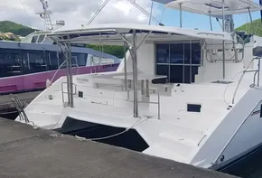 2017 Leopard 48 catamaran docked at marina with scenic mountain backdrop.