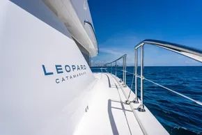 2025 Leopard 40 Powercat catamaran cruising on open sea under clear blue sky.