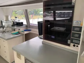 Modern kitchen interior on a 2021 Leopard 45 catamaran, featuring appliances and ample counter space.