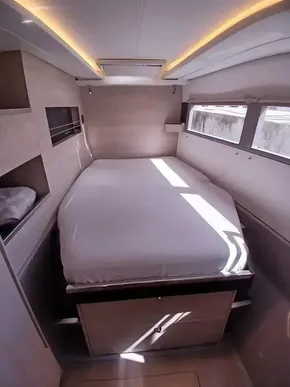 Cozy bedroom in 2019 Leopard 45 yacht with modern design and natural light.