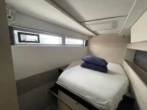Compact bedroom interior in a 2020 Leopard 50 yacht, featuring a cozy bed and modern design.
